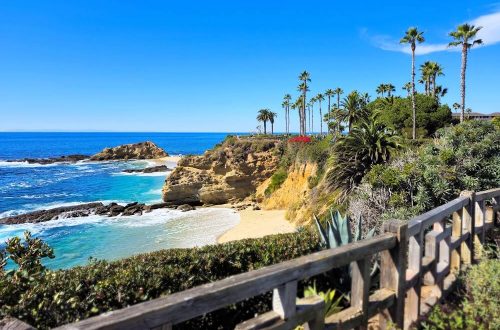 View of a turquoise water and white sand beach in Laguna Beach, California